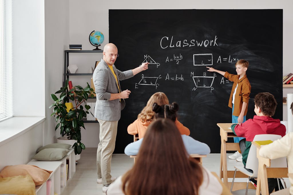 A teacher and students in a classroom during a geometry lesson, focused and engaging.