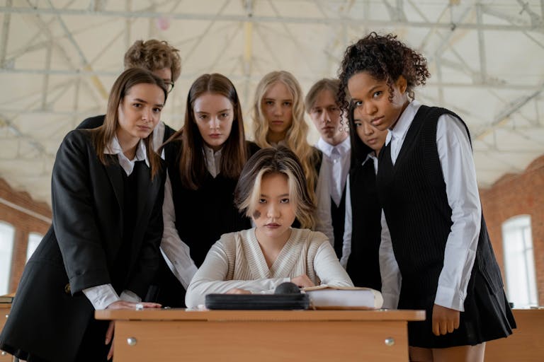 Group of students in a classroom portraying themes of peer pressure and bullying.