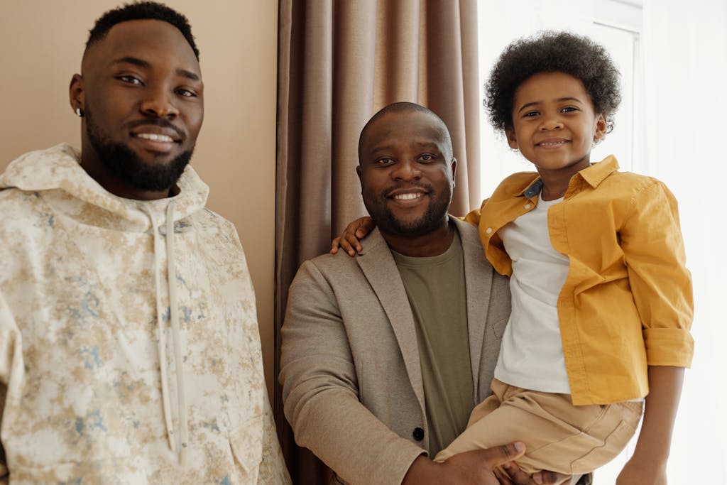 Joyful father and son smiling together indoors, showcasing family happiness.