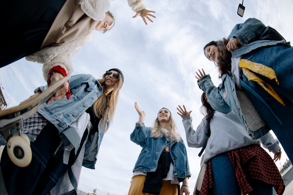 Low angle view of teenagers in casual outfits enjoying time at a skate park